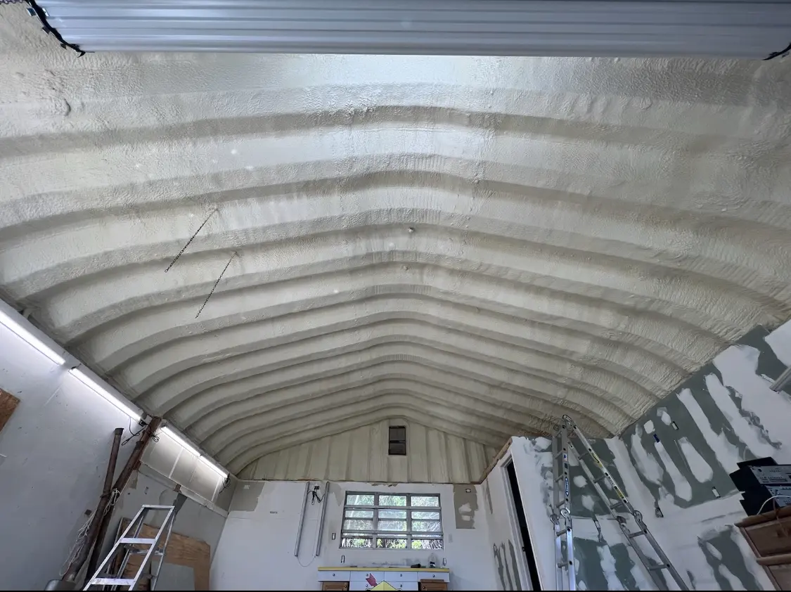 Spray polyurethane foam applied to the underside of a metal roof deck in Etowah